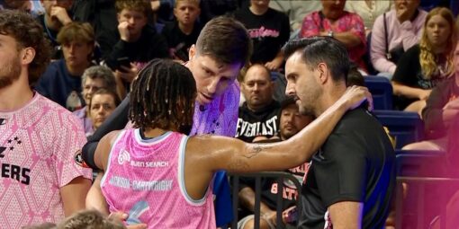 Nathan Trebilco stands with NZ Breakers players.