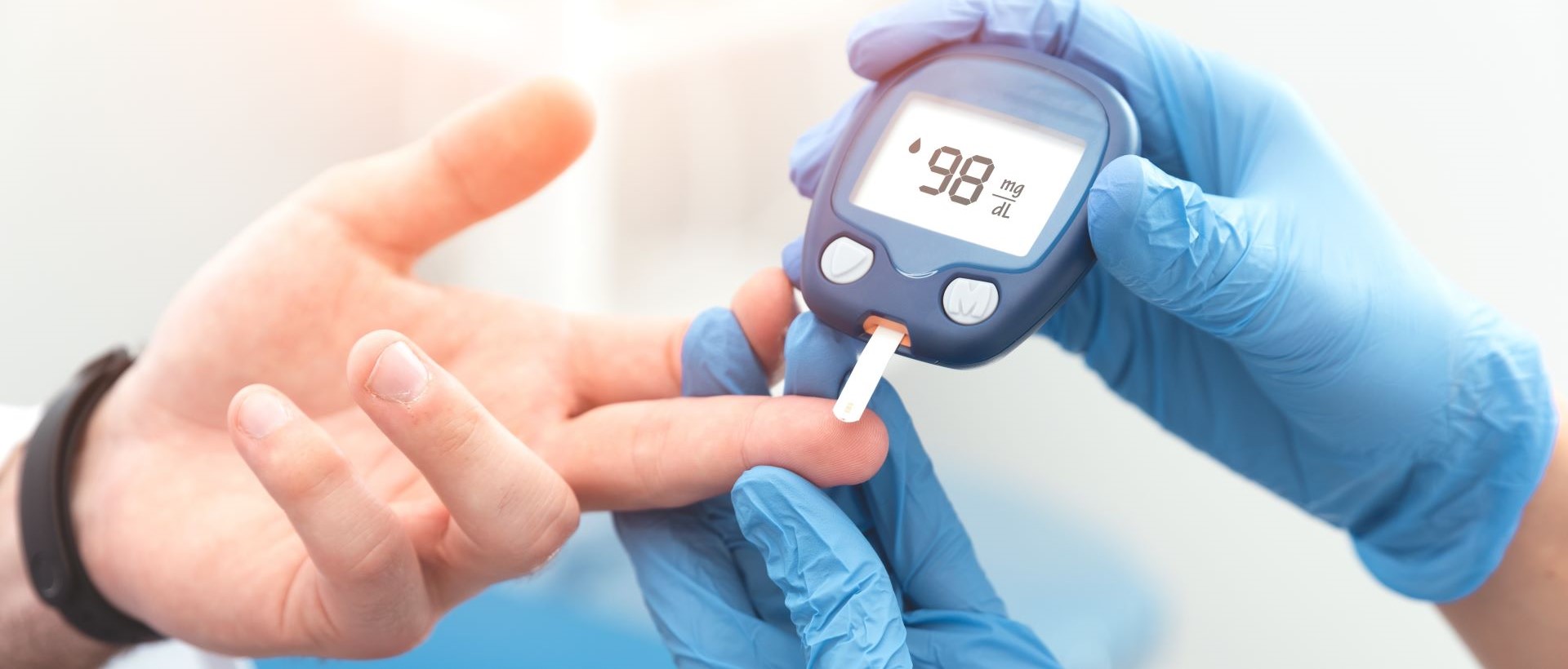 Health professional takes blood sugar measurement.