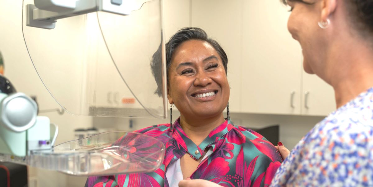 A cheerful Chathams Islands woman has a mammogram.